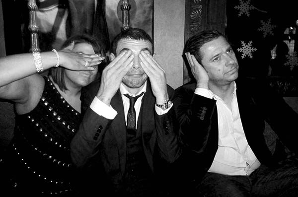 Three people doing 3 wise monkeys