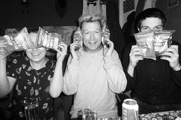 Three people using crisp packets doing 3 Wise Monkeys