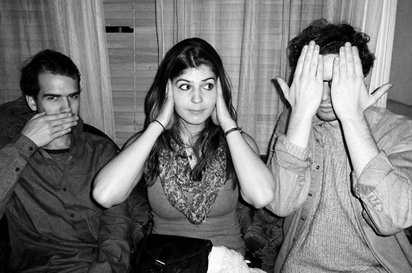 Three people doing 3 wise monkeys
