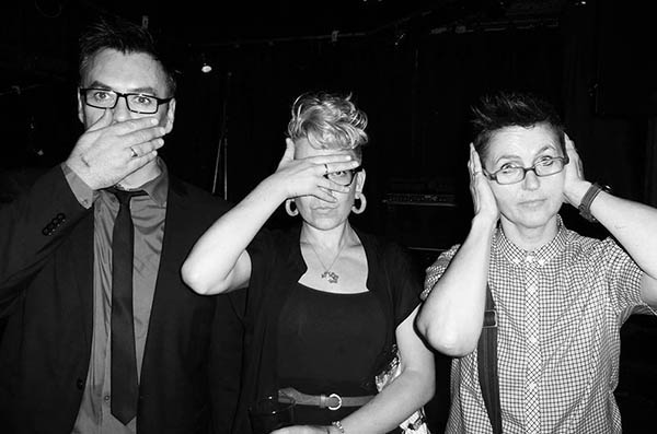 Three people in a pub doing 3 Wise Monkeys