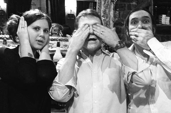 Three people doing 3 wise monkeys