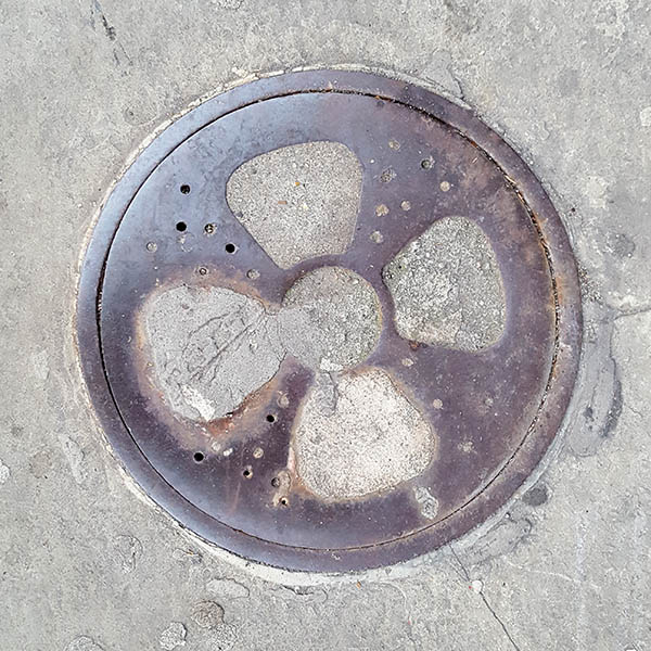Manhole Cover, London - Cast iron with concrete propeller pattern