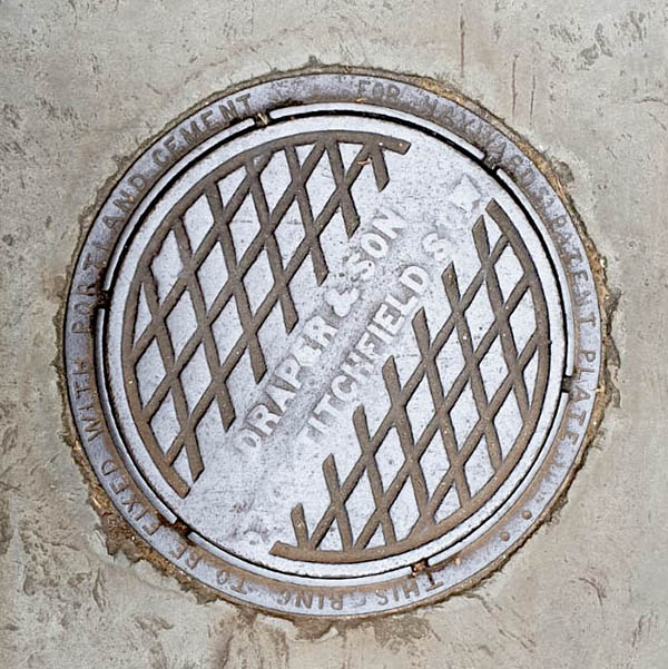 Manhole Cover, London - Cast iron criss cross pattern with diagonal text