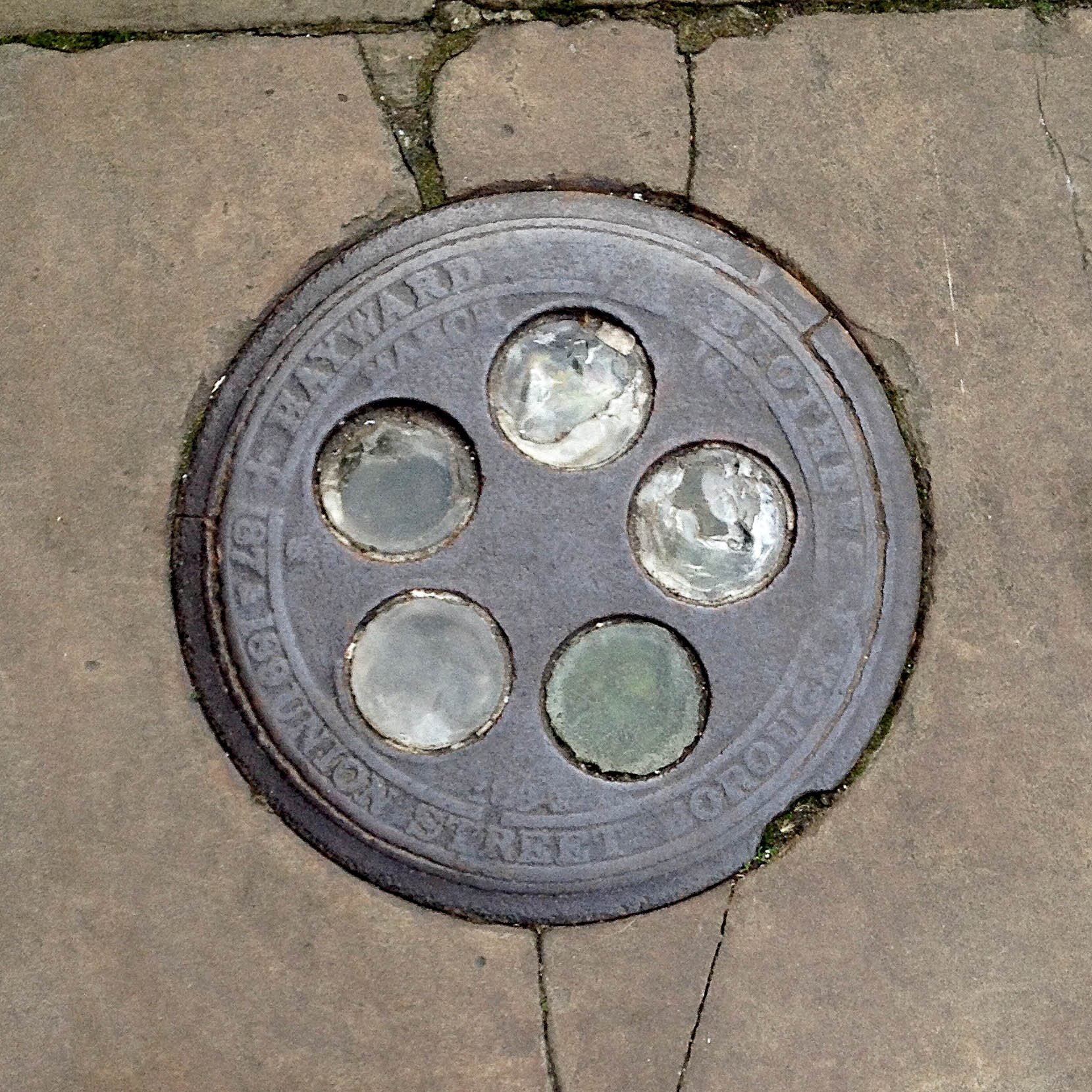 Manhole Cover, London - Cast iron - surround inscribed with Hayward Brothers 187 & 189 Union Street Borough - Inner, five glass circular inserts