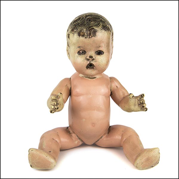 Vintage composition doll with damaged face