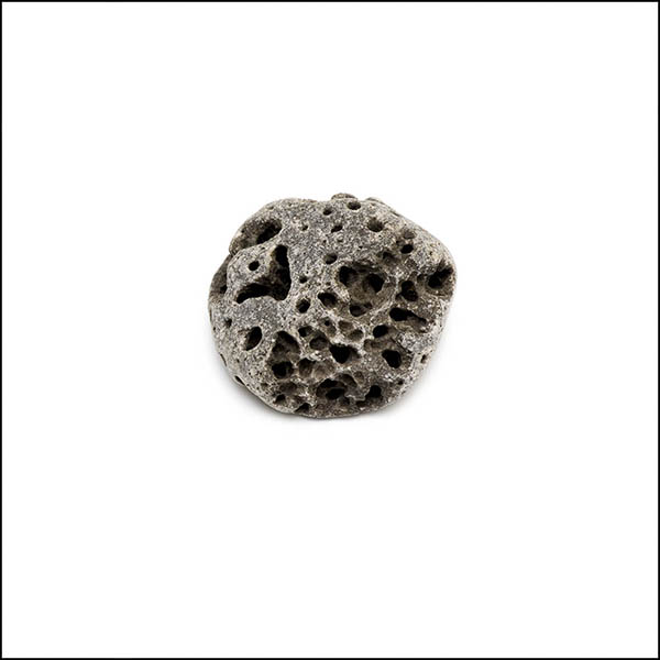 Pebble - round, warm grey, pitted eroded