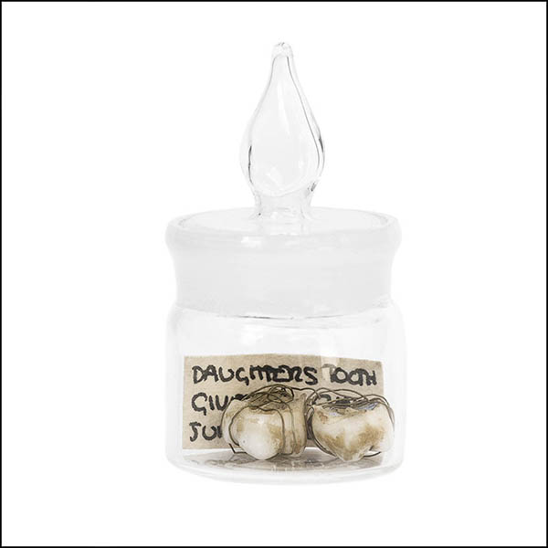 Baby teeth in glass pot - part of tooth collection