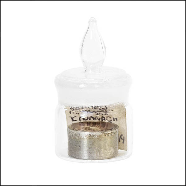 Baby tooth in resin in glass pot - part of tooth collection