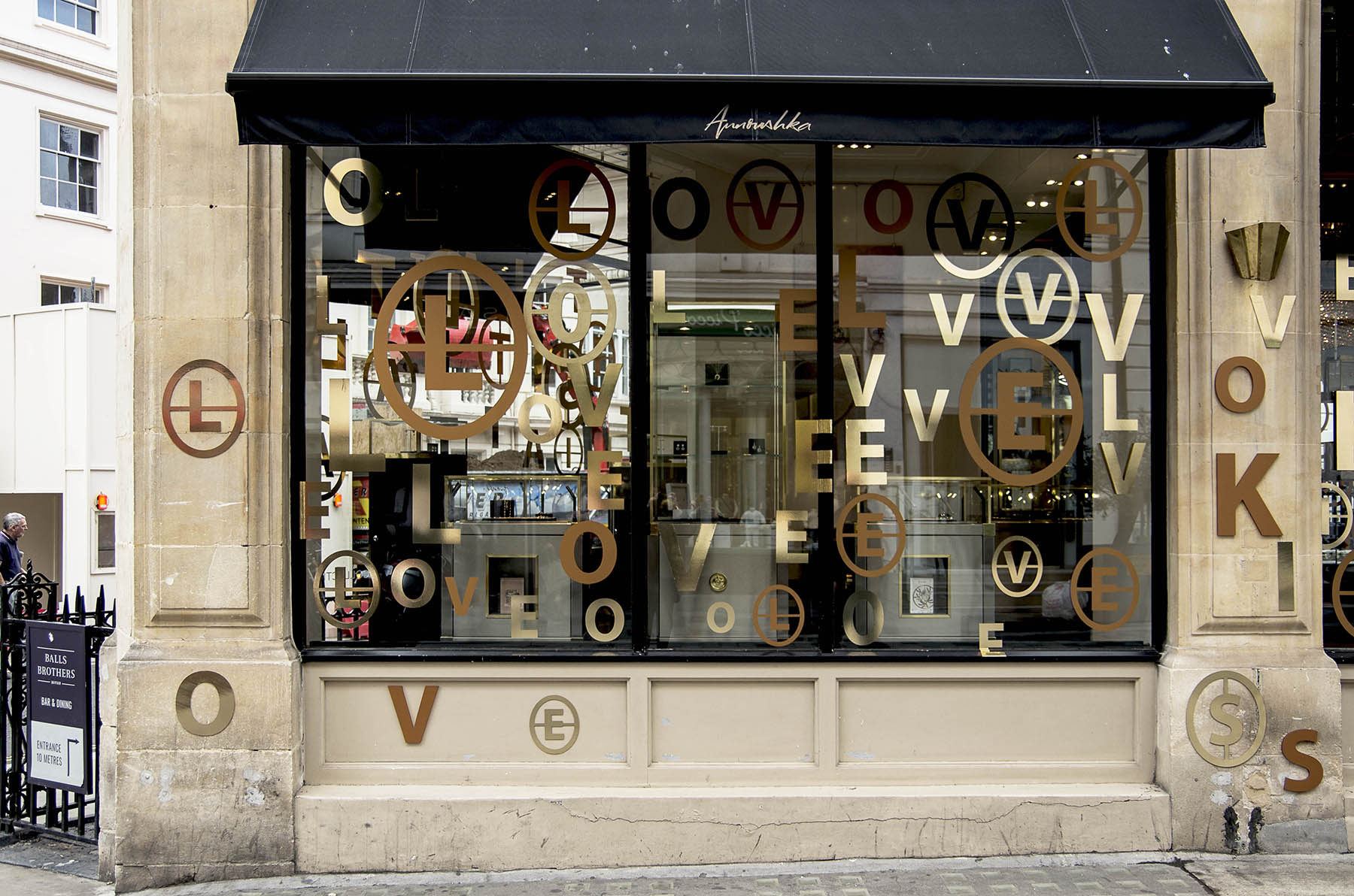 Annoushka Initials window display - gold and copper letters spelling Love
